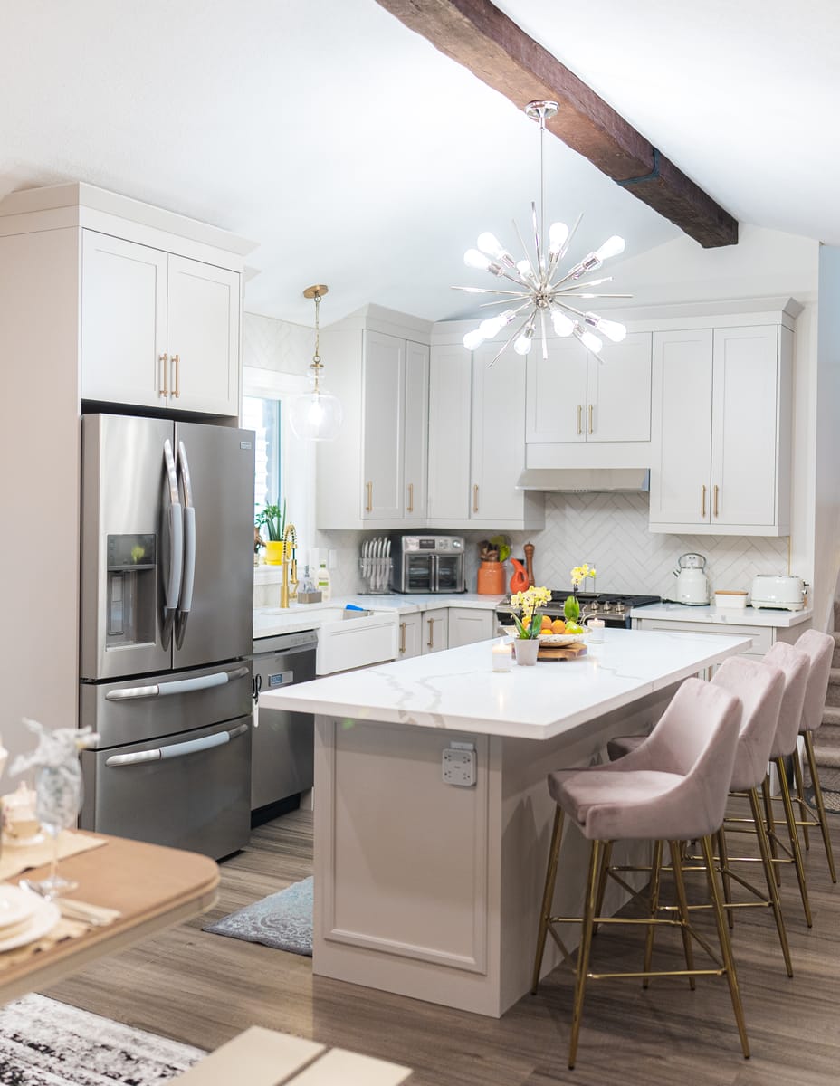 Finished custom kitchen renovation by AC Custom Reno — white cabinetry and quartz waterfall island