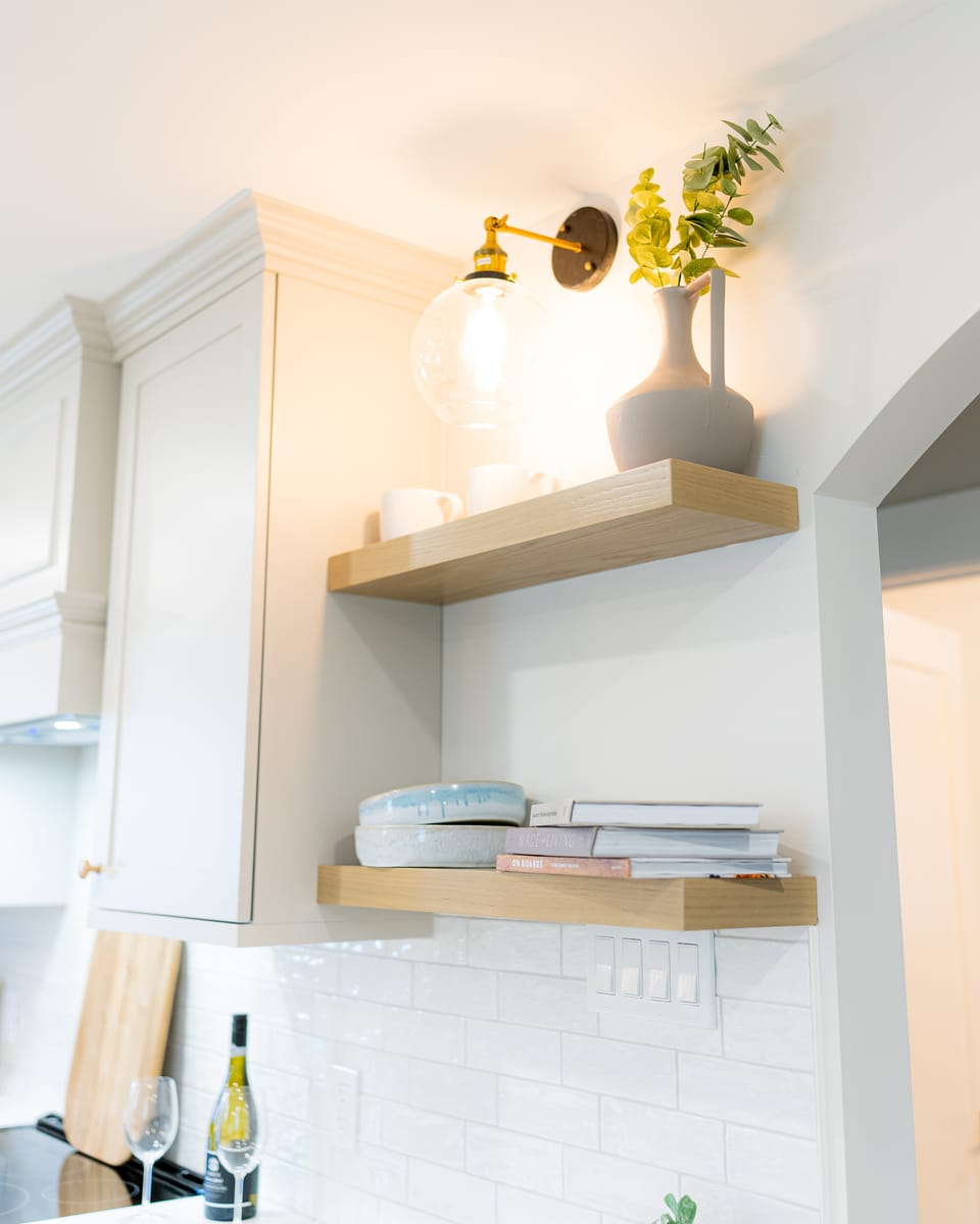 Custom open shelving with sconce lighting